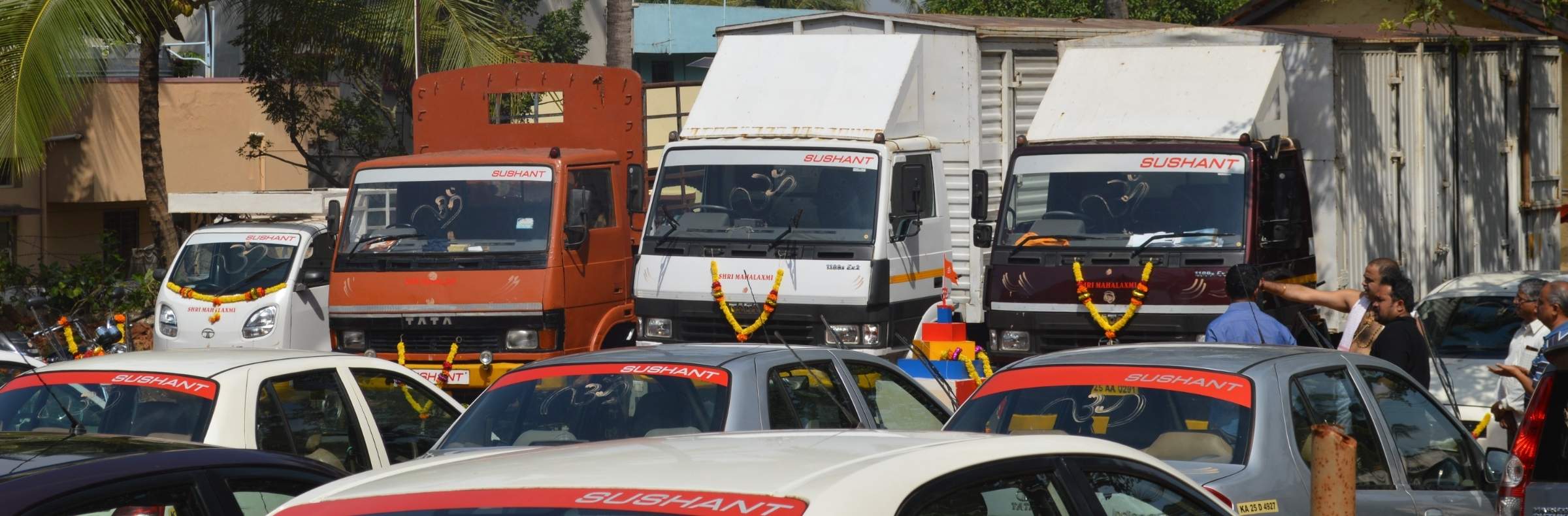 Sushant-branded trucks and taxis parked in a row