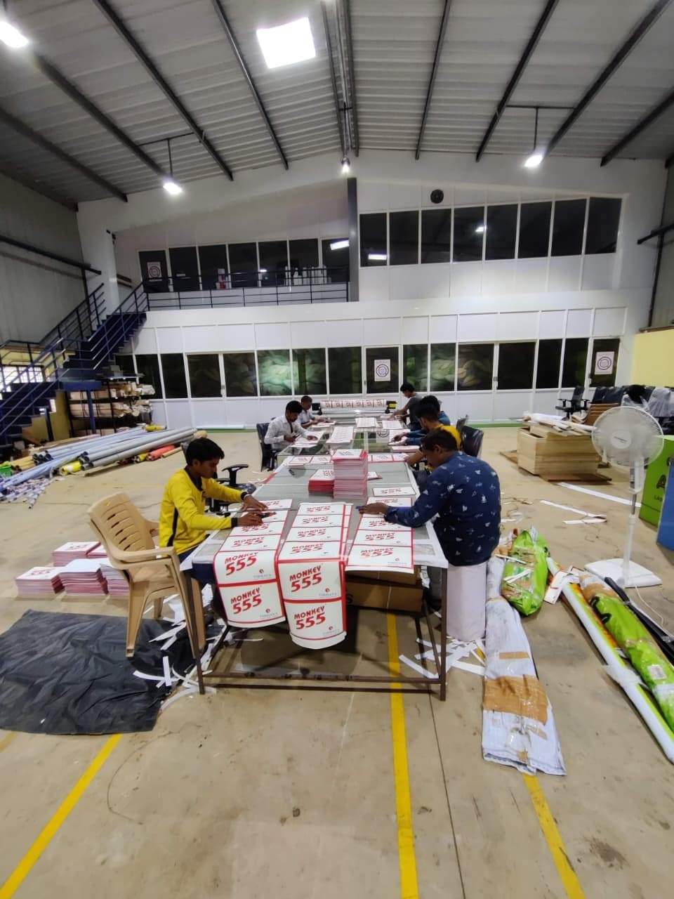 Production staff assembling printed boards at the Belur floor tables