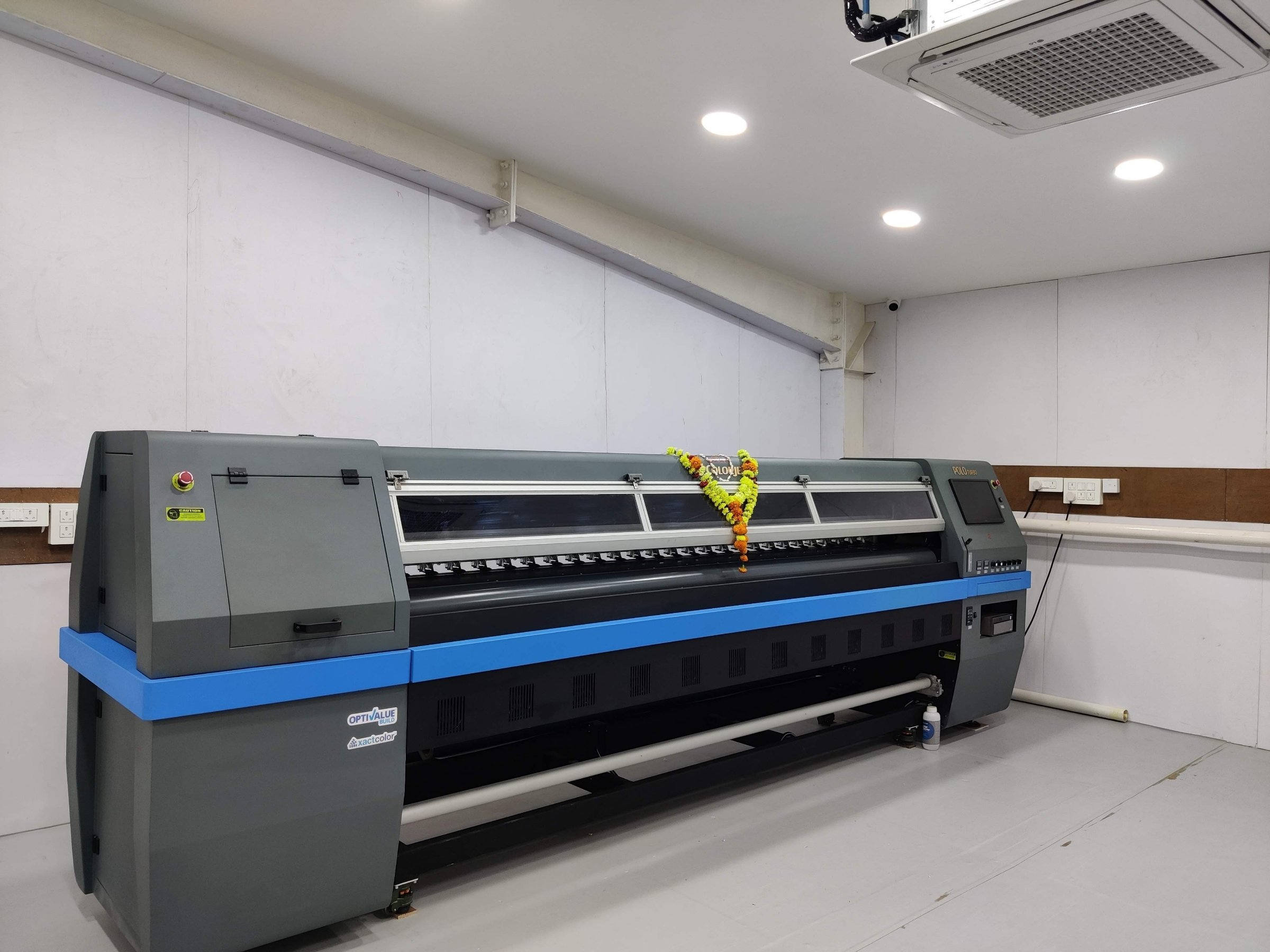 Wide solvent roll-to-roll printer installed in the print room.